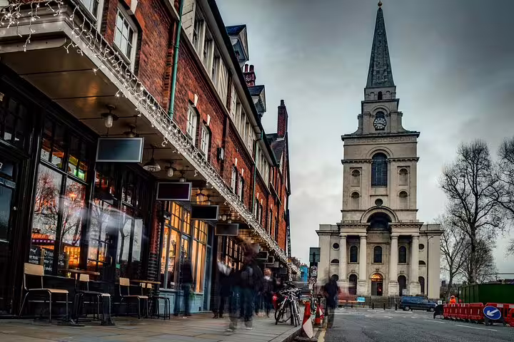Christ Church Spitalfields at dusk with blurred pedestrians on Commercial Street, London