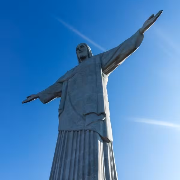Majestic Christ the Redeemer statue under a bright sky, featured in Rio's private tour of top attractions.
