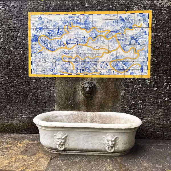 Decorative tiles and stone basin in Tijuca Forest, showcasing cultural charm on a Christ the Redeemer tour.