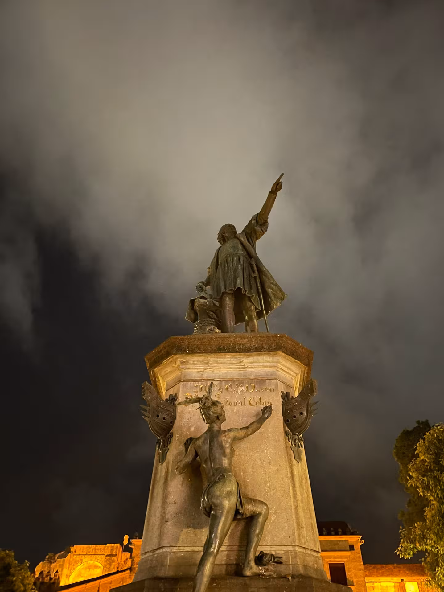Illuminated Christopher Columbus monument in Santo Domingo at night, iconic highlight of Dominican culture tour