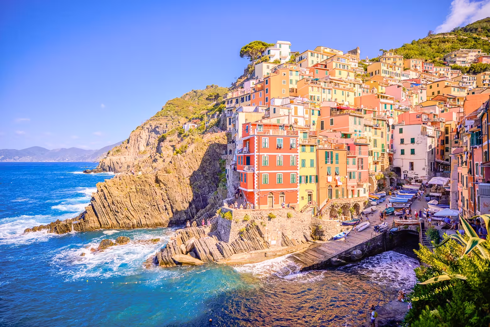 Scenic view of colorful cliffside houses in Cinque Terre overlooking the blue waters of the Gulf of the Poets.