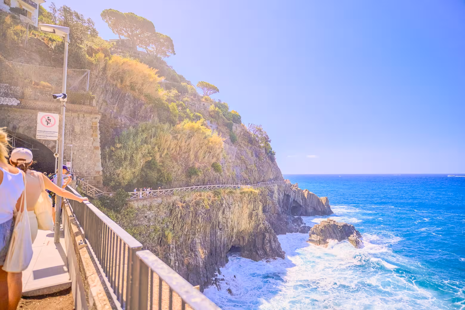 Hikers enjoying scenic coastal views on a sunny day during the Cinque Terre tour from La Spezia Train Station.