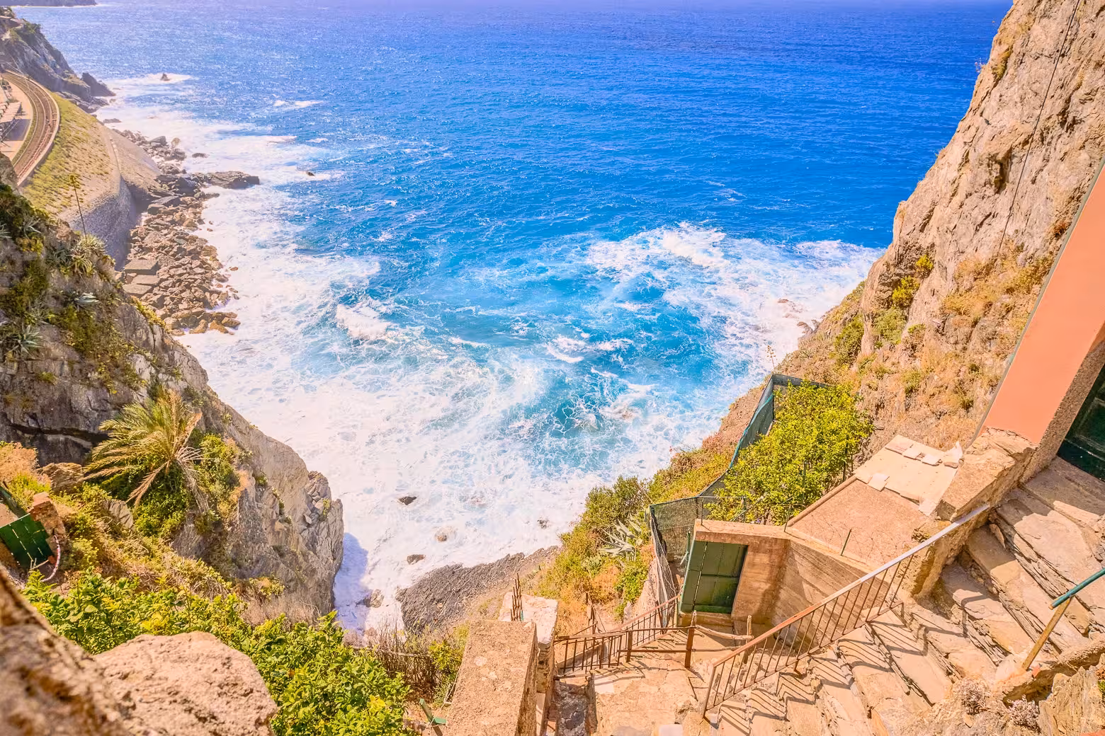 Scenic view of rocky cliffs and vibrant blue sea along the Cinque Terre coastline, showcasing natural beauty on a private tour.