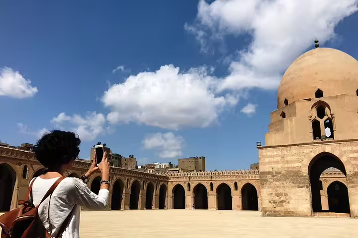Traveler photographing historic mosque courtyard on Citadel, Bazaar and Cairo Mosques Tour in Islamic Cairo