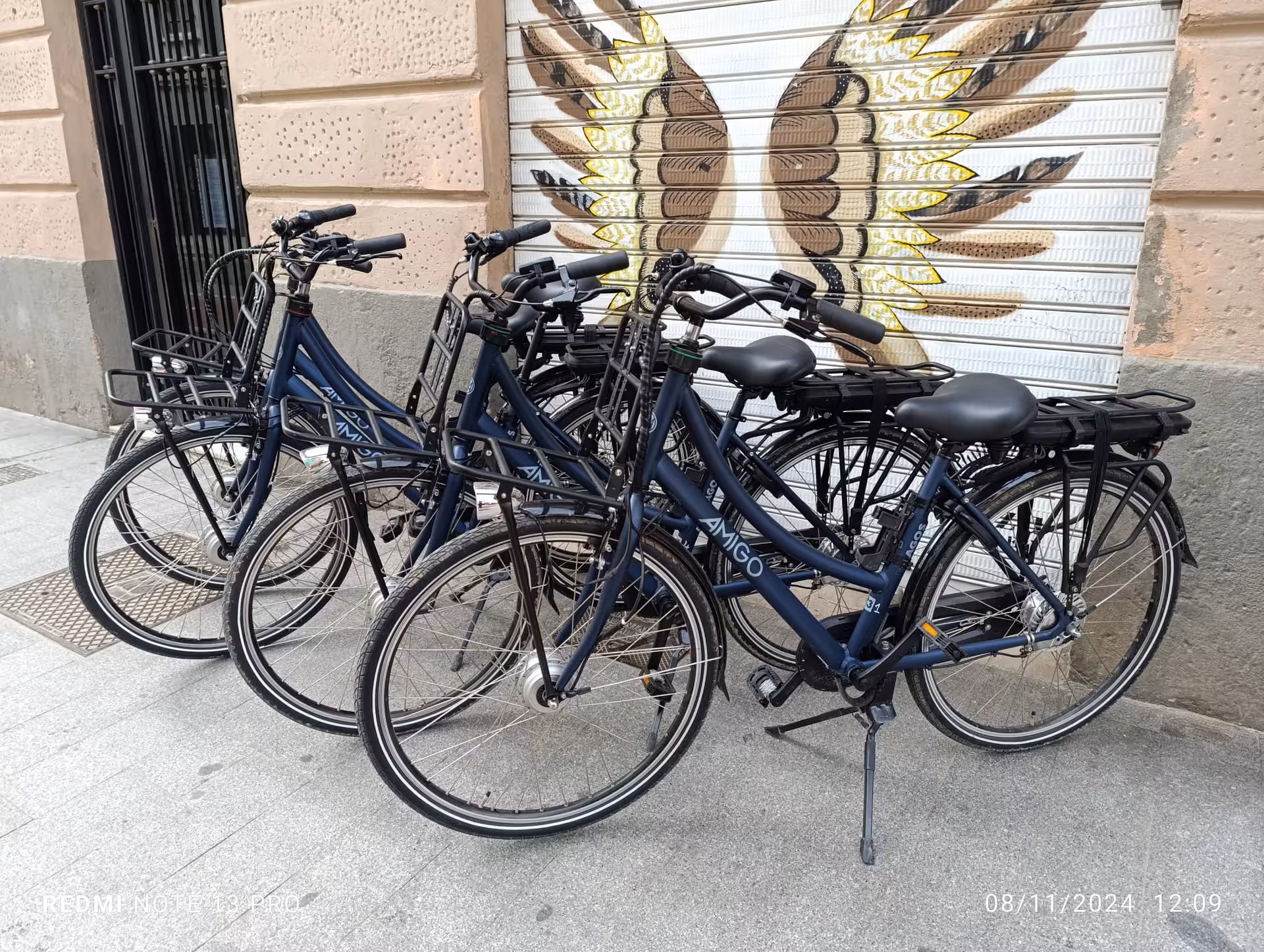 Fleet of city electric bikes for rent parked on a street, ideal for self-guided urban sightseeing tours
