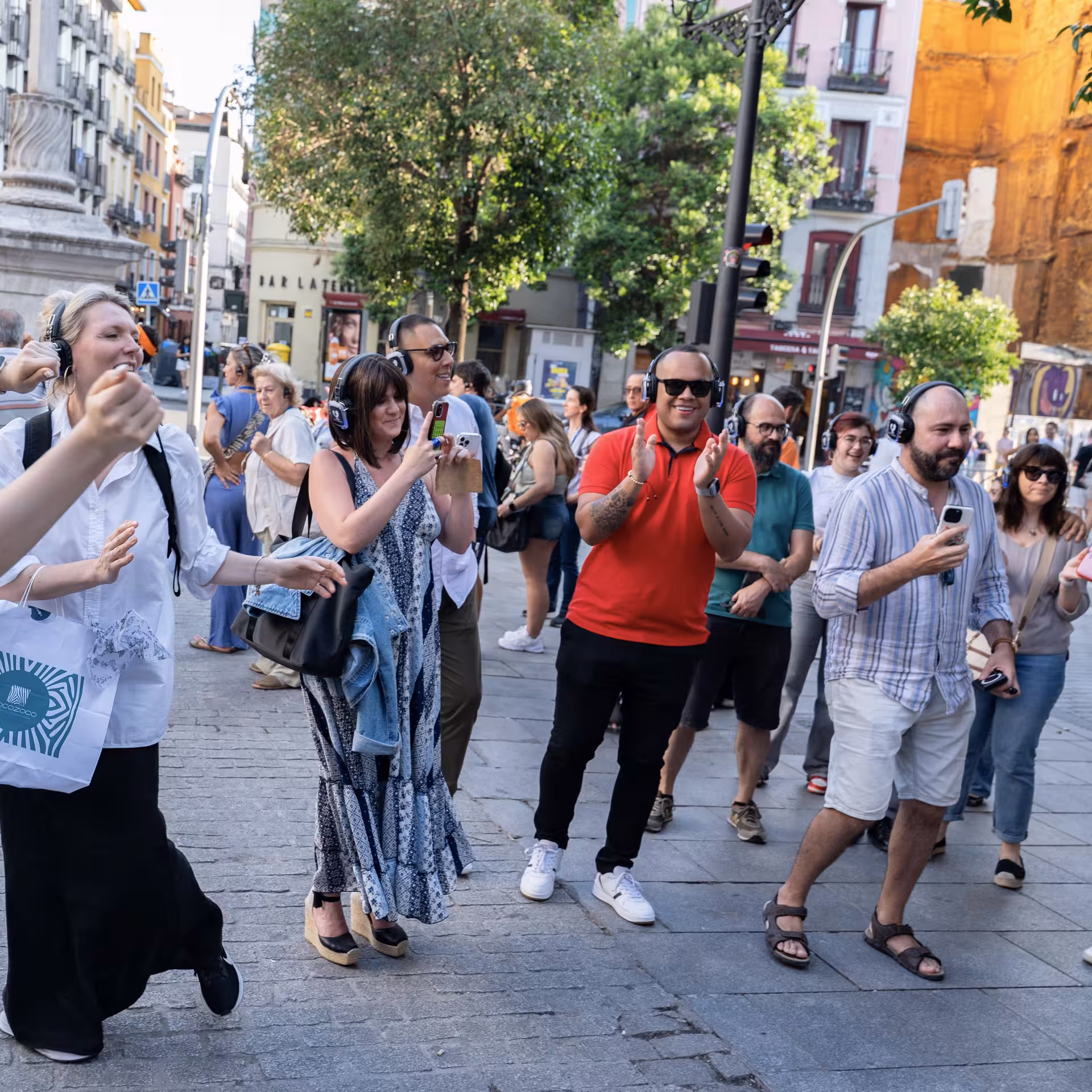 Group enjoying an engaging CityVoice walking tour in Madrid, capturing moments in a vibrant urban setting.