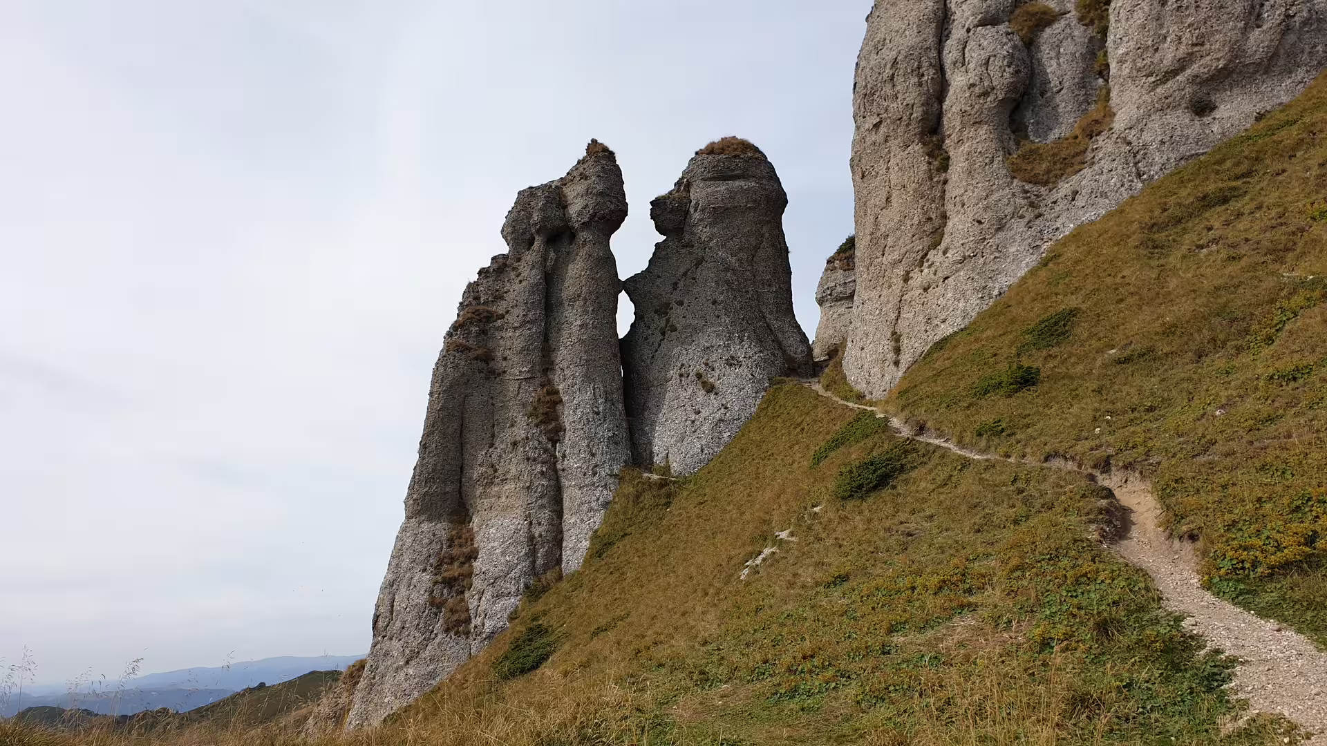 Tall limestone rock pillars along a hiking trail on Ciucas Peak, Romania