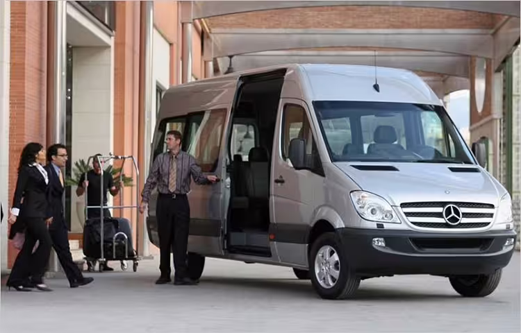 Business travelers boarding a modern Mercedes minivan for a shared transfer from Civitavecchia Port to Fiumicino Airport