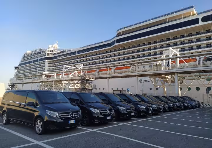 Row of luxury Mercedes vans providing Civitavecchia cruise port transfers for VIP Rome tour with golf cart ride and Colosseum visit