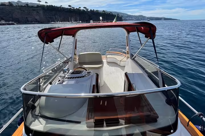 Interior view of a classic Gozzo 7.50 boat with comfortable seating, perfect for a private tour from Sorrento to Capri.
