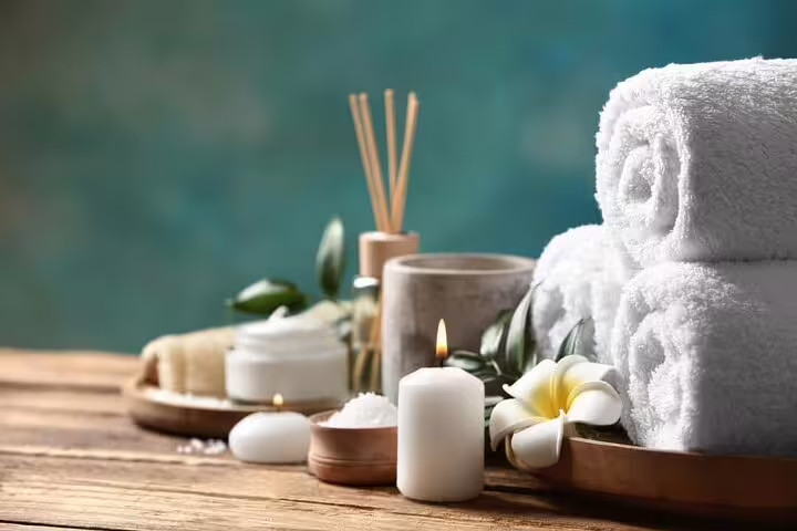 Spa towels, candles and bath salts set for Cleopatra Deluxe VIP spa treatment with massage, sauna and jacuzzi