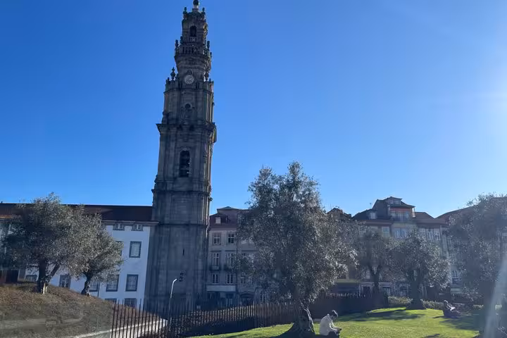 Iconic Clérigos Tower rising above Porto old town on a sunny day during a historic walking tour