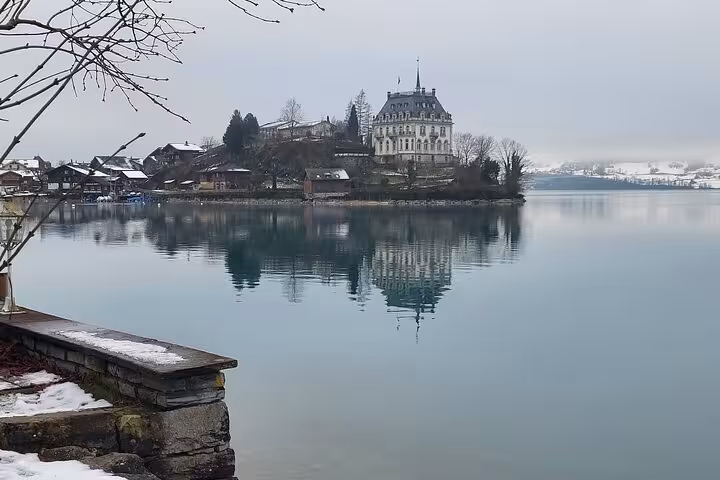 Historic lakeside mansion reflecting in calm water on Crash Landing on You private tour.