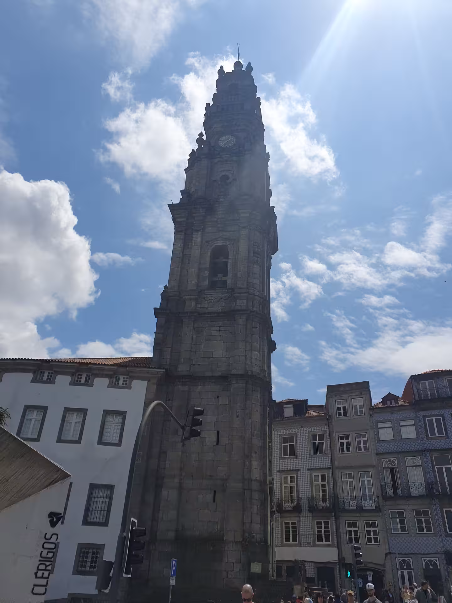 Marvel at the iconic Clérigos Tower in Porto, a must-visit landmark with stunning baroque architecture under a sunny sky.