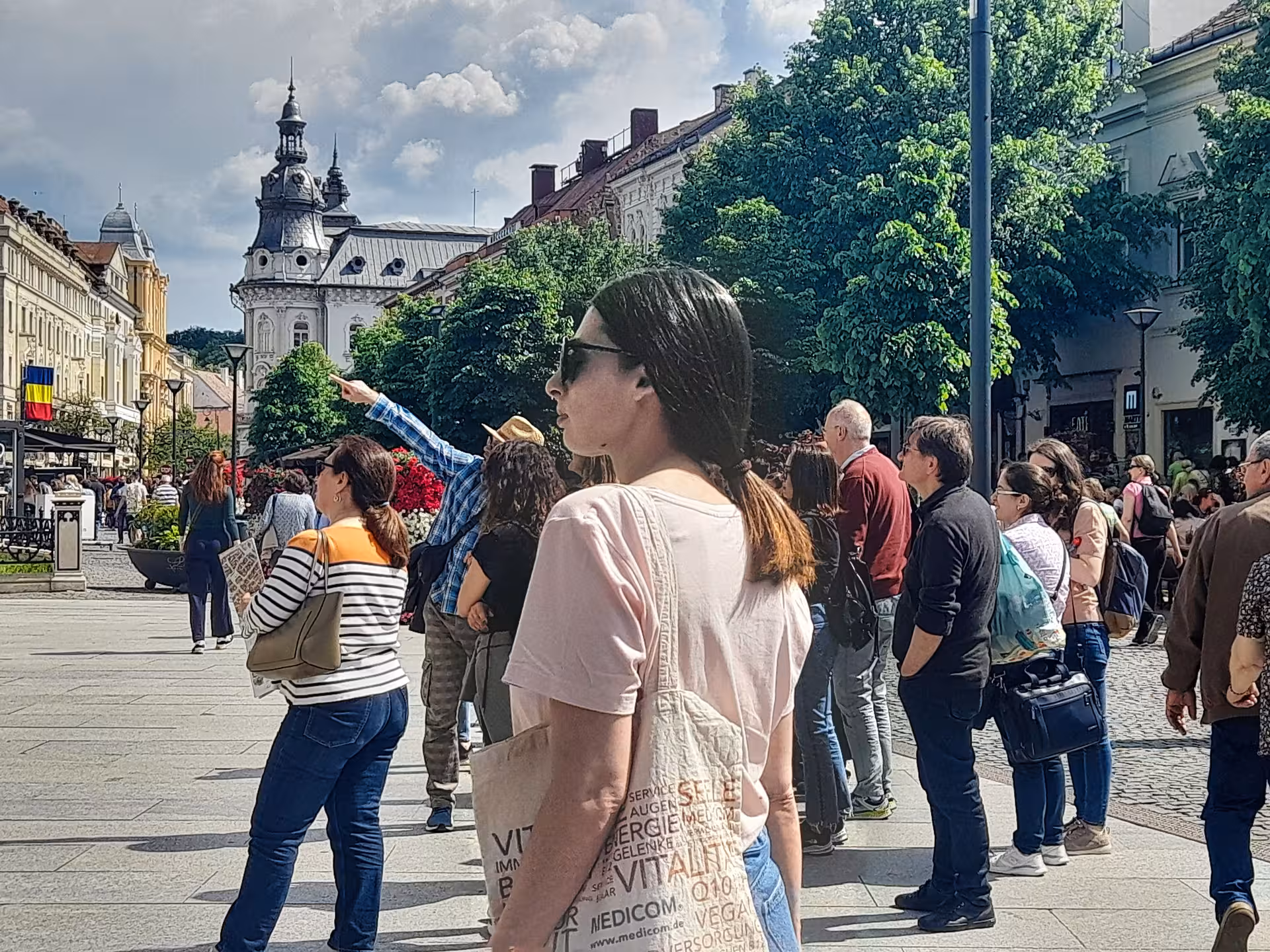 Tourists exploring Cluj-Napoca's vibrant city center square on a guided history and hidden secrets walking tour