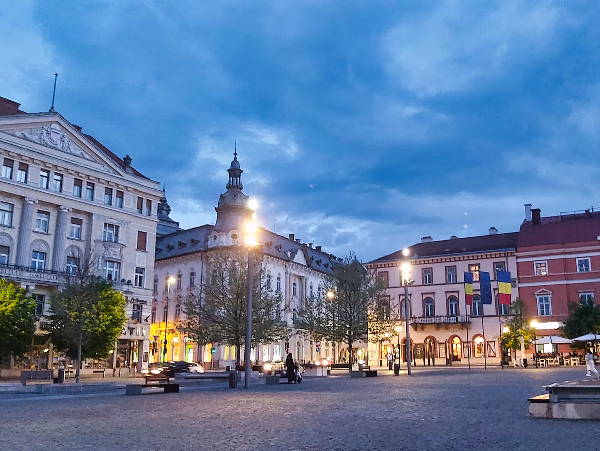 Cluj-Napoca historic main square at dusk with illuminated baroque buildings on guided walking history tour