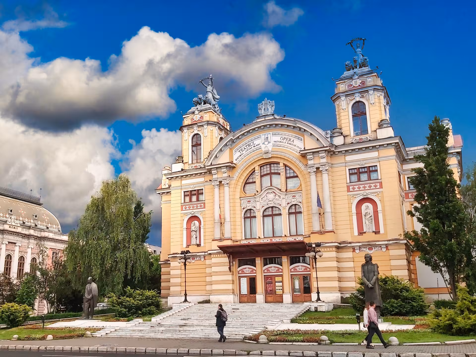 Grand baroque facade of Cluj-Napoca National Theatre and Opera seen on a guided walking history tour of Romania