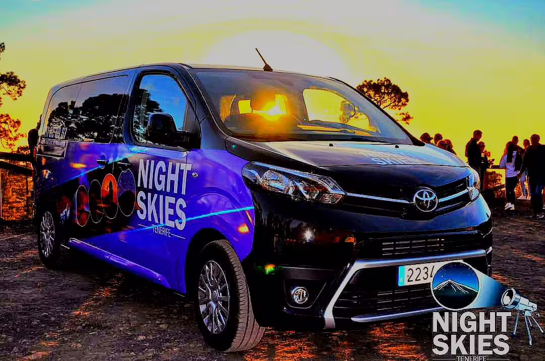 Comfortable tour van ready for Tenerife sunset and stargazing safari, parked against a scenic backdrop with evening glow.