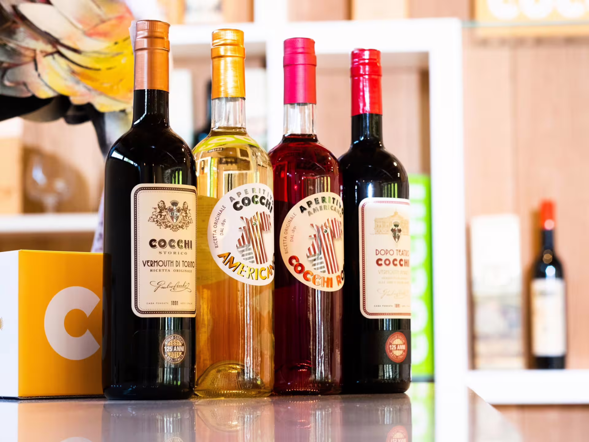 Selection of premium Cocchi vermouth bottles displayed for tasting in Turin city center.