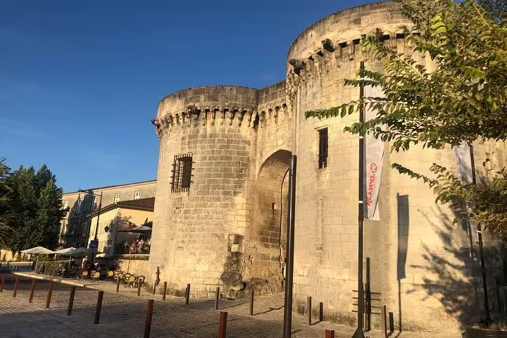 Historic stone gate and towers in Cognac, France, landmark stop on a self-guided e-scavenger hunt tour
