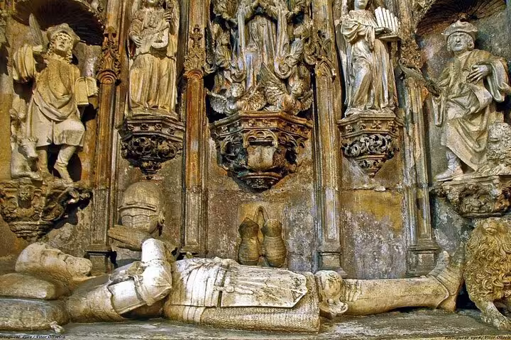 Intricate medieval stone carvings and statues in Coimbra's historic cathedral interior.
