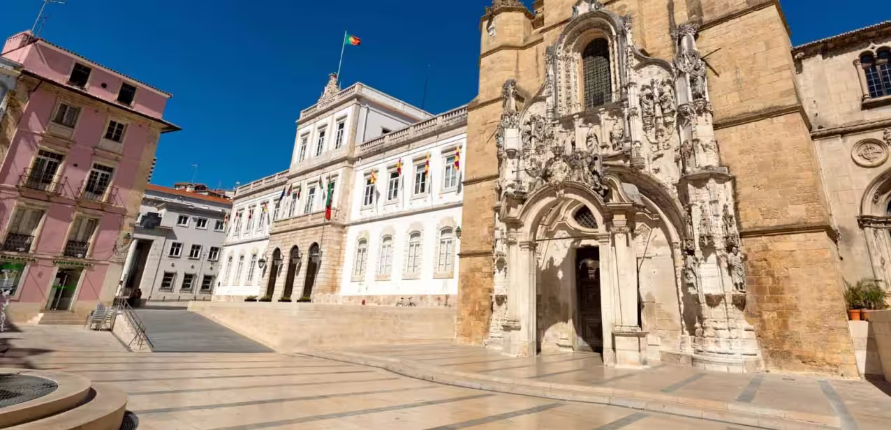 Historic architecture in Coimbra's city center, showcasing intricate stonework and vibrant buildings, featured on the Lisboa private tour.