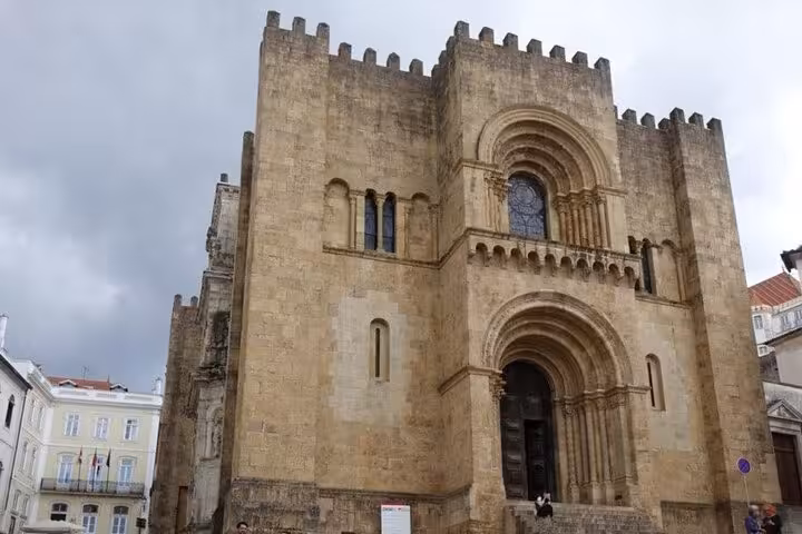 Explore Coimbra's historical charm with a private walking tour featuring the iconic Old Cathedral of Coimbra.