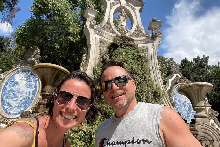 Couple selfie at Coimbra landmark with azulejo tiles, exploring the Coimbra scavenger hunt self-guided tour
