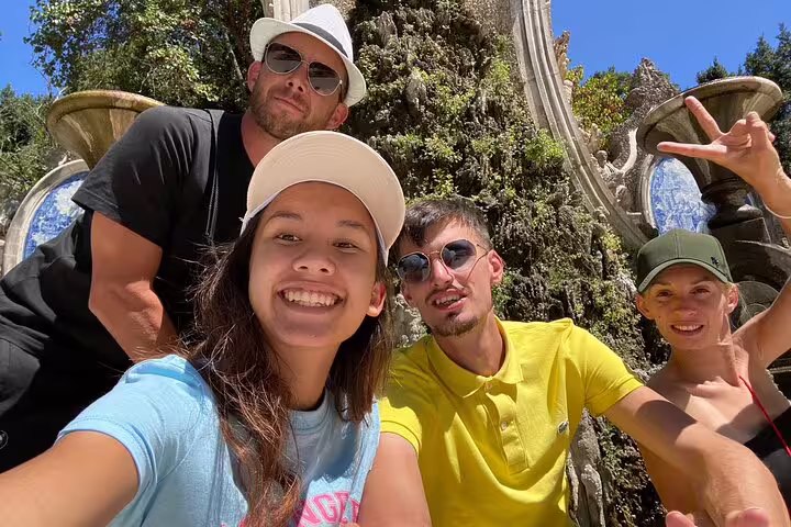Friends group selfie at Coimbra scenic monument on a self-guided scavenger hunt and sightseeing tour in Portugal