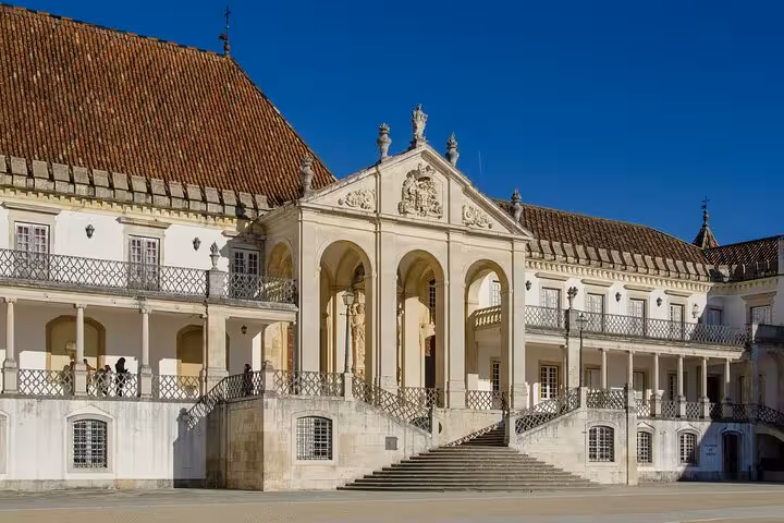 Admire the stunning architecture of Coimbra University's historic courtyard during a private city walk with a local guide.