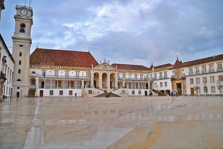 Historic courtyard of University of Coimbra with grand architecture on a small group walking tour.