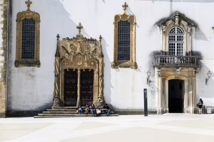 Historic architecture of Coimbra University in Portugal, showcasing ornate stonework and classic European design for self-drive tours.