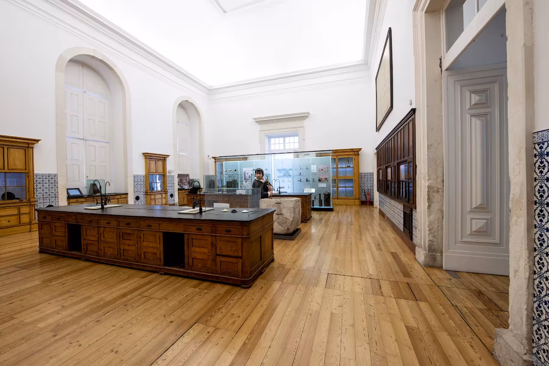 Spacious interior of Coimbra University with wooden desks, high ceilings, and historical displays on a private guided tour.