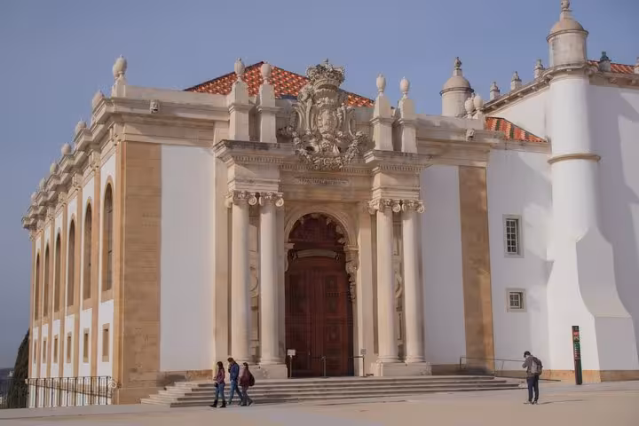 Ornate entrance of the University of Coimbra's library, highlighting the tour's architectural focus.