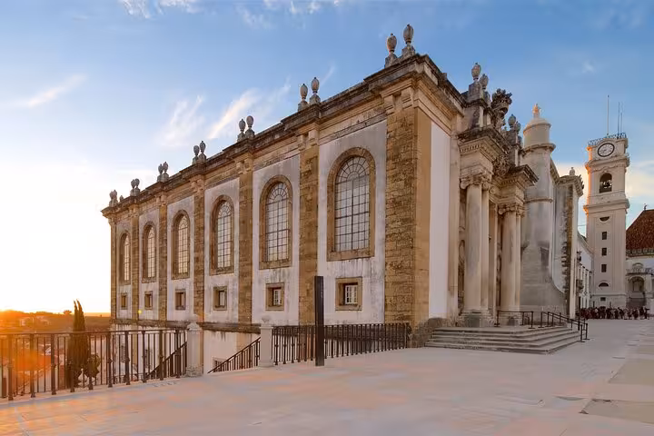 Sunset view of Coimbra's historic University Library, highlighting its grand facade and cultural significance.