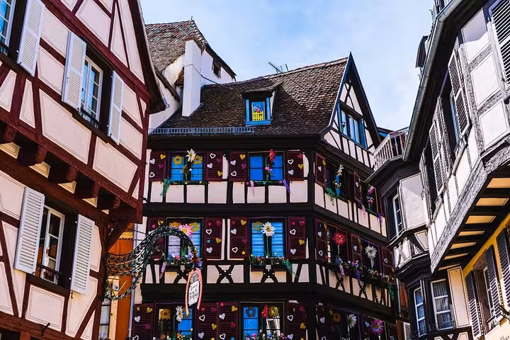 Colorful half-timbered medieval buildings with floral decorations in Colmar, Alsace, France