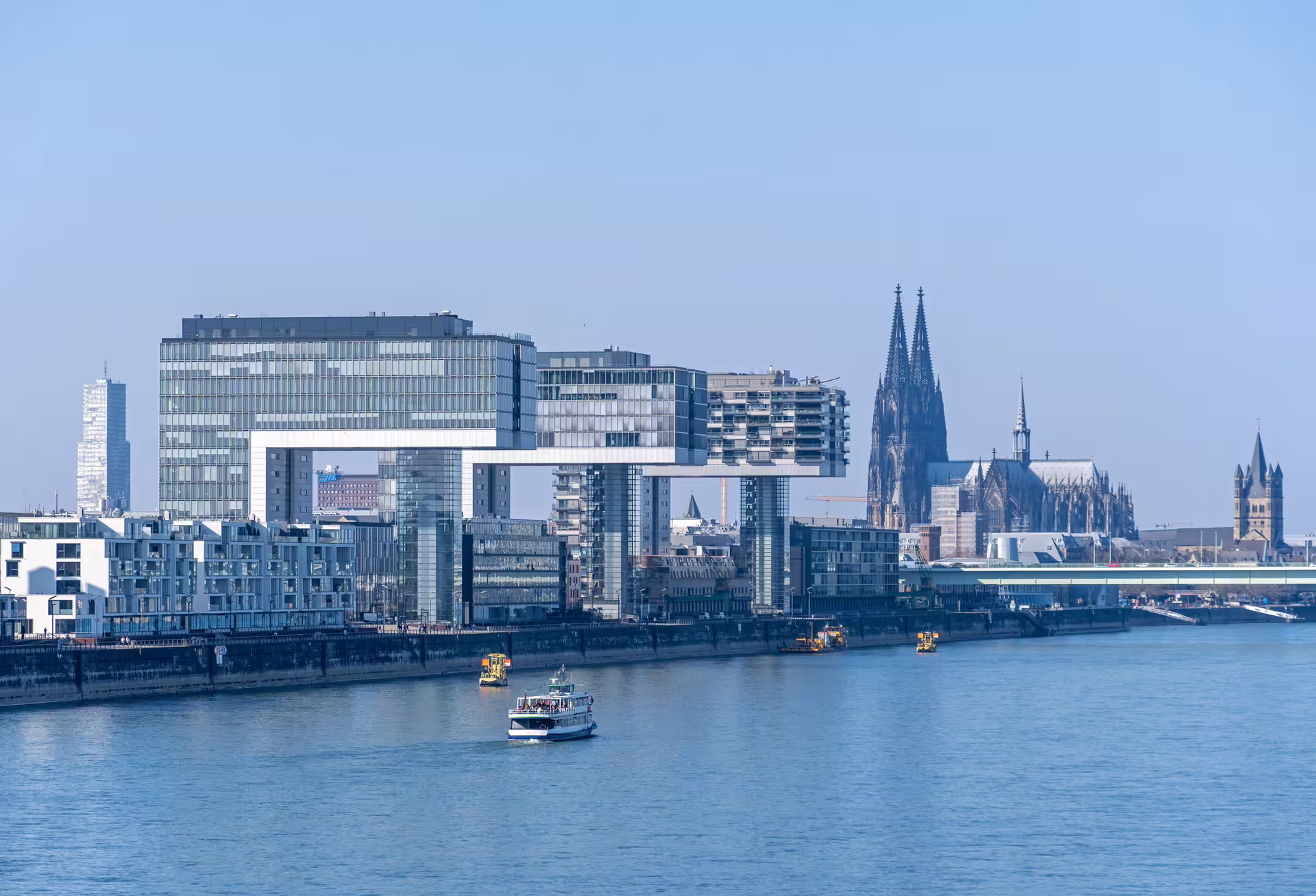 Cologne Rhine riverfront with Kranhäuser and Cathedral spires, featured on 1-day walking audioguide tour