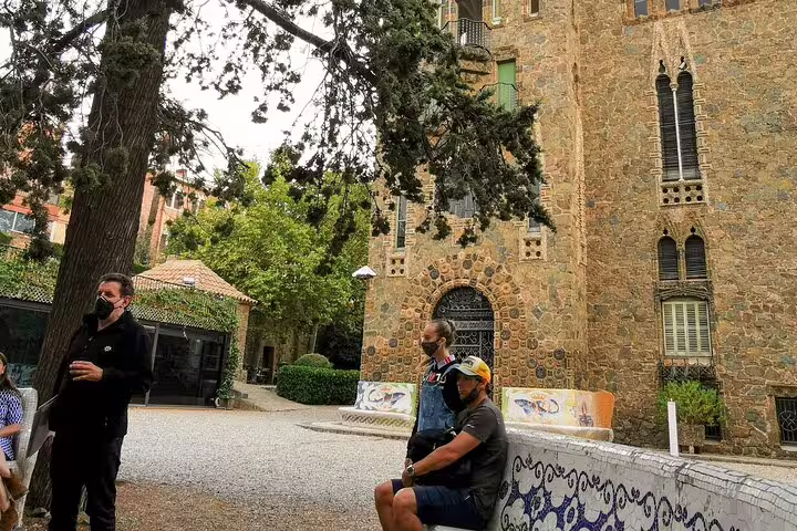 Visitors enjoy the architecture of Colonia Guell during a private skip-the-line tour, highlighting Casa Vicens in Barcelona.