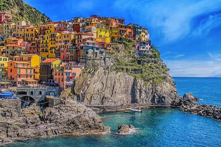 Colorful cliffside village with vibrant buildings overlooking the blue Mediterranean Sea in southern Italy