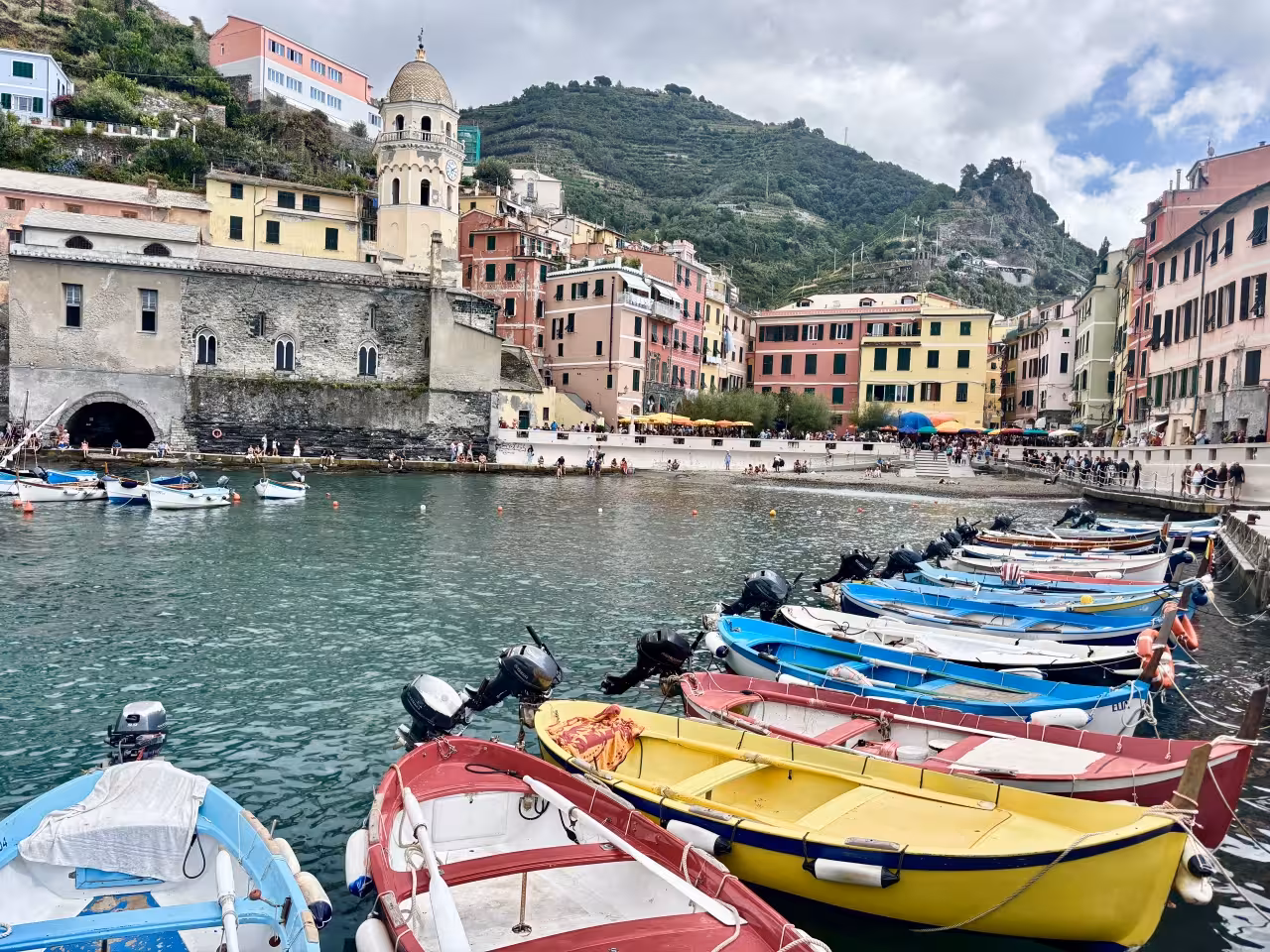 Colorful fishing boats in Vernazza marina, Cinque Terre, seen on a full-day boat tour departing La Spezia
