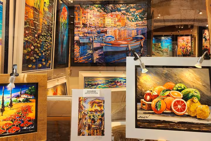 Vibrant art display featuring colorful paintings of the French Riviera, perfect for art lovers and culture enthusiasts.