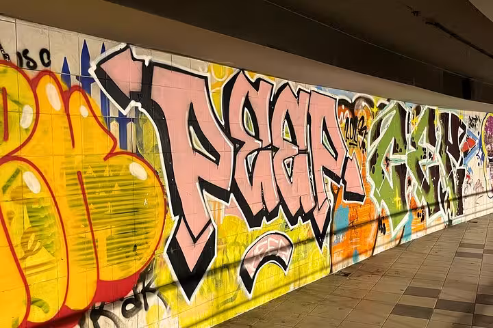 Colorful street art wall with bold graffiti lettering, perfect for Sip and Spray graffiti and cocktails tour