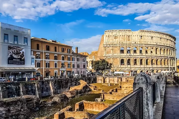 View of the Colosseum and ancient ruins with vibrant cityscape, ideal for an express tour of Rome's historic sites.