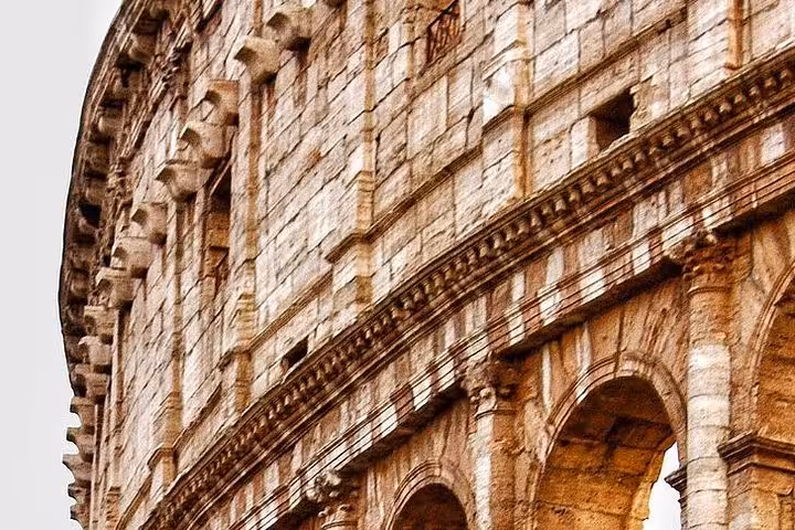 Detailed view of the Colosseum's exterior arches and stonework, exemplifying the grandeur of ancient Roman engineering.