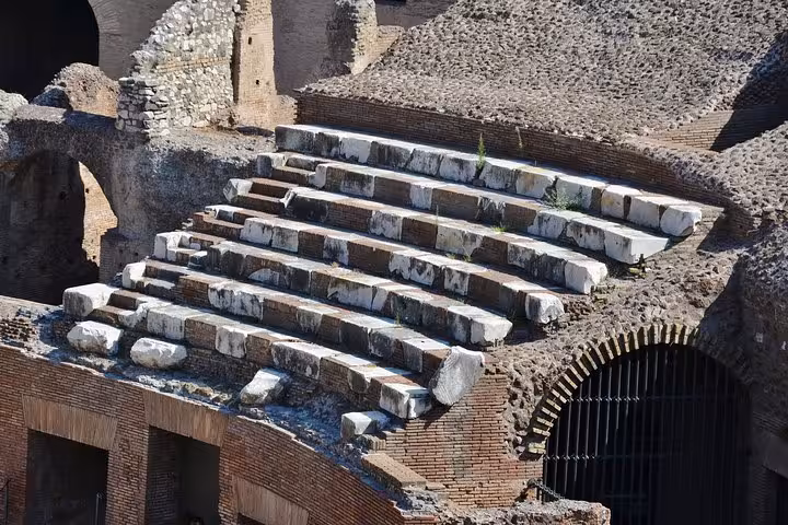 Close-up of the Colosseum's ancient stone seating showcasing Roman architectural mastery on the Express Tour.