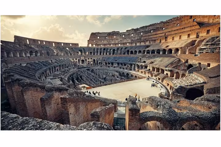 The Colosseum's arena floor bathed in warm sunlight, highlighting the grandeur of this historical Roman amphitheater.