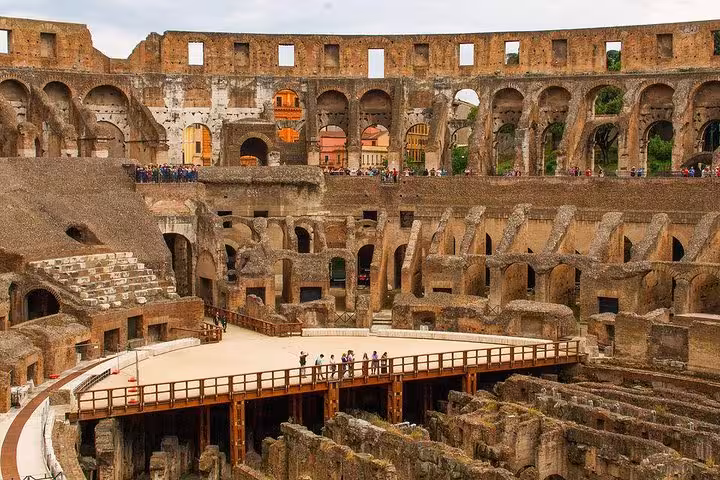 Experience the grandeur of the Colosseum's arena floor with VIP access, offering stunning views of Rome's iconic landmark.