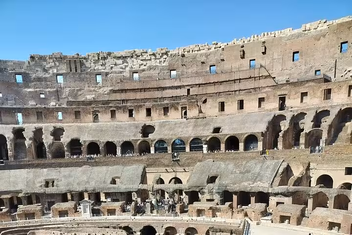 Interior view of the Colosseum showcasing ancient seating and architectural details, perfect for a guided Rome tour.