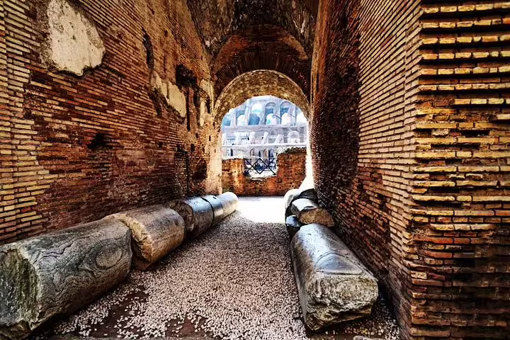 Ancient brick corridor and fallen marble columns inside the Colosseum on an official guided tour of Rome’s gladiator arena