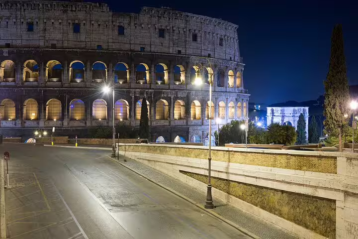 Night view of the illuminated Colosseum in Rome with quiet streets, captured during an evening small-group guided tour